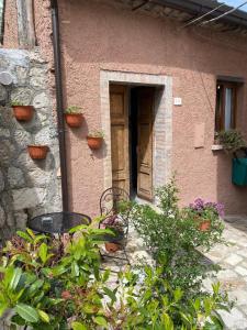 a house with a bench and plants in front of it at I Cento Portali - Albergo Diffuso in Pignola