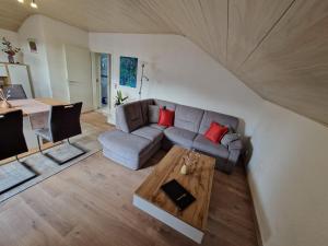 a living room with a couch and a table at Ferienwohnung Harmonie in Sulzbach