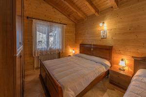 Ένα ή περισσότερα κρεβάτια σε δωμάτιο στο Albergo Diffuso Forgaria Monte Prat