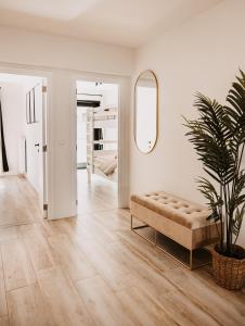 a living room with a couch and a mirror at Ostend Centre Bayview Apartment + Free Parking in Ostend