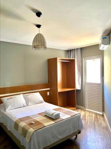 فندق بورتو سلفادور في سلفادور: غرفة نوم بسرير واضاءة