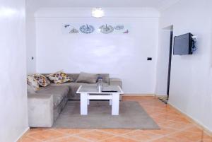 a living room with a couch and a table at Airport apartment 2 