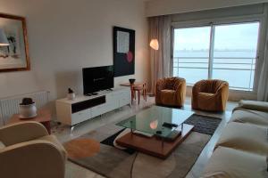 a living room with a couch and a tv at Beautiful Apartement with Lakeview in Tunis