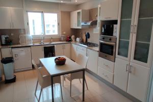 a kitchen with a table with a bowl of fruit on it at Beautiful Apartement with Lakeview in Tunis