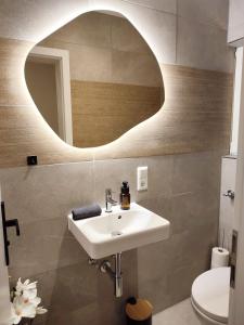 a bathroom with a sink and a mirror at Ferienwohnung Haus Mediterran max. 6 Pers. in Radolfzell am Bodensee +18 photos