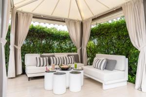 a gazebo with white couches and a table at The Nai Harn in Nai Harn Beach