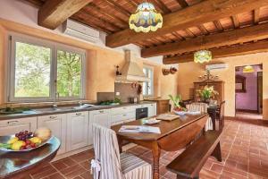 a kitchen with a wooden table and a dining room at Casa Ilenia in Marciano