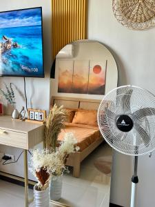 a living room with a couch and a fan at Condo in Lapu-Lapu City in Lapu Lapu City