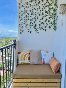 a bench on a balcony with plants on the wall at Condo in Lapu-Lapu City in Lapu Lapu City