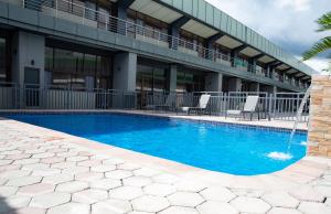 a swimming pool in front of a building at Gloria Inn Hotel - Ndola in Ndola