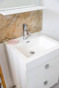 - un lavabo blanc avec un robinet en chrome dans l'établissement Charmant T2 au cœur de Ducos, à Ducos