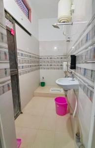 La salle de bains est pourvue d'un lavabo et d'une baignoire. dans l'établissement SiyaRam Homestay, à Faizābād
