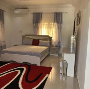 a small bedroom with two beds and a rug at PARADISE VIEW #73 in Banjul