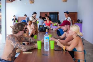 a group of people in bathing suits sitting at a table at My Mate's Place Gili Air in Gili Air