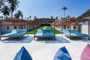 a group of blue lounge chairs on a patio at My Mate's Place Gili Air in Gili Air