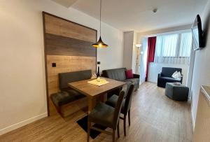 Una sala de estar con mesa de comedor y sillas. en Holiday Residence Mesenhaus, en Maranza