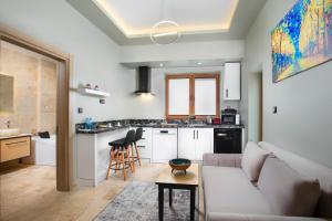 a living room with a couch and a kitchen at Acer Living Home in Ortahisar