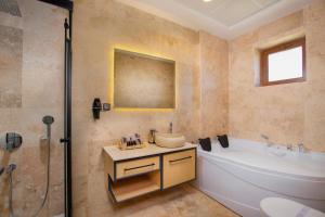 a bathroom with a tub and a sink and a shower at Acer Living Home Cappadocia in Ortahisar +33 photos