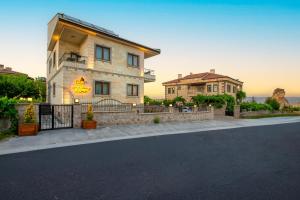 a house with a fence in front of a street at Acer Living Home Cappadocia in Ortahisar