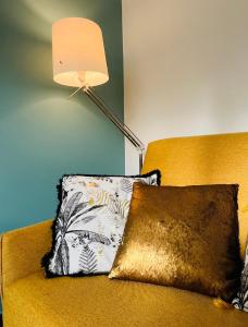 a lamp sitting next to a couch with a pillow at Proche Avignon au calme in Les Angles Gard +9 photos