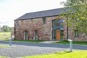 a brick building with a door on the side of it at Brockram & Keld Barns in Kirkby Stephen