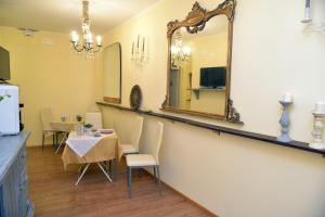 a dining room with a table and a mirror at Lavanda e Rosmarino in Sandigliano