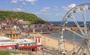 a city with a ferris wheel and a beach at The Black Swan Hotel in Scarborough