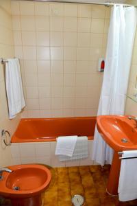a bathroom with a tub and a toilet and a sink at LagosMar Story Hotel in Lagos