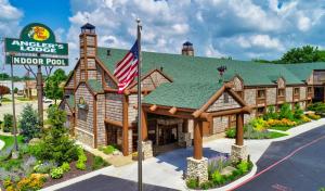 a lodge with an american flag in front of it at Bass Pro Shops Angler's Lodge in Springfield