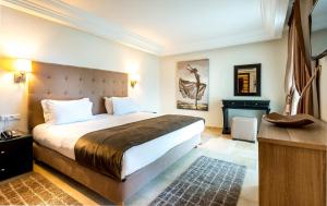 a bedroom with a large bed and a desk at Hotel Rabat - A member of Barceló Hotel Group in Rabat
