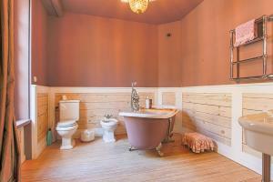 a bathroom with a tub and a toilet and a sink at Duplex d'exception face Hippodrome avec Jardin in Chantilly