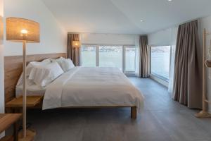 ein Schlafzimmer mit einem großen Bett und einem großen Fenster in der Unterkunft Villa Patria B&B in Brusino Arsizio
