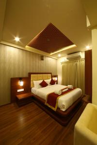 a bedroom with a large bed and a couch at Royal Stay in Bengaluru +138 photos