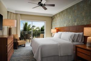 a hotel room with a bed and a balcony at The Westin Ka'anapali Ocean Resort Villas in Lahaina