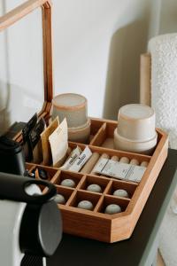 a wooden box filled with different items on a table at Het Hart Van Alem in Alem