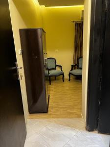 an open door to a room with two chairs at Alaaeldein pyramids Land inn in Cairo