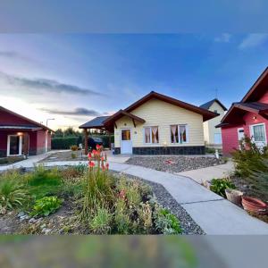a house with a driveway in front of it at Corinto Tempo in Esquel +1 photo