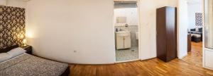 a bedroom with a bed and a bathroom with a sink at Sofia Central Guest Rooms in Sofia