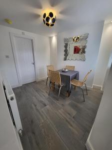 a dining room with a table and chairs at 10 old church street in Cefn-coed-y-cymmer