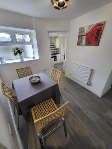 a dining room with a table and chairs at 10 old church street in Cefn-coed-y-cymmer