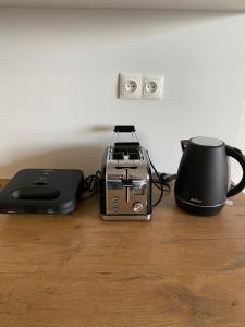 a toaster and a coffee maker on a table at Apartament Browarna in Nowy Sącz