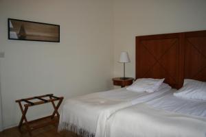 a bedroom with two beds and a picture on the wall at Stadshotellet Sölvesborg in Sölvesborg