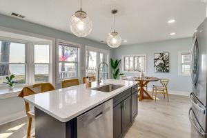 a kitchen with a sink and a counter top at Bayfront Maryland Retreat with Deck, Near Beaches! in North Beach
