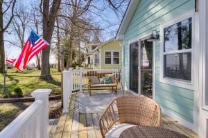 a house with a flag on the front porch at Bayfront Maryland Retreat with Deck, Near Beaches! in North Beach