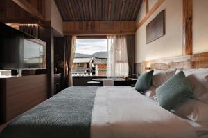 a bedroom with a large bed and a large window at Humble abode of happiness - Mountain View Wabi-sabi Lodge in Lijiang