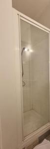 a shower with a glass door in a bathroom at HOTEL ABOUKIR in Paris