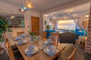 a dining room and living room with a table and chairs at The White Cottage in Woolacombe