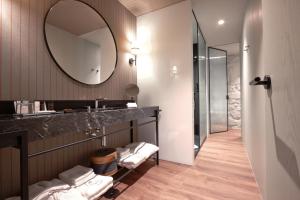 a bathroom with a sink and a mirror at Hotel das Virtudes in Porto