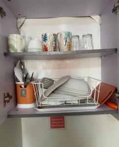 a shelf with plates and dishes in a refrigerator at Saekyung Village One-Phase 2 in Lapu Lapu City