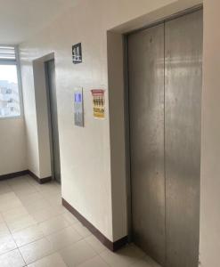 a hallway with two elevators in a building at Saekyung Village One-Phase 2 in Lapu Lapu City +16 photos